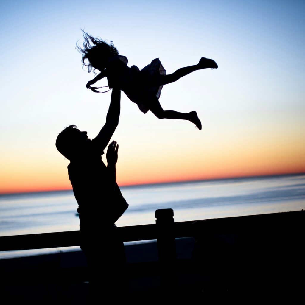 Father tossing child in air